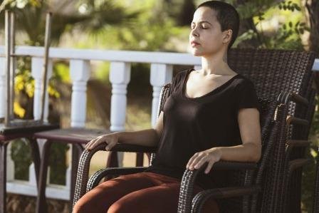 Women meditating on a chair